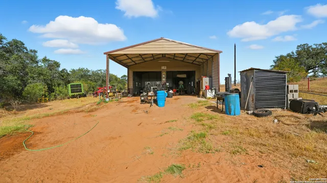 a view of a garage with a bike and white car