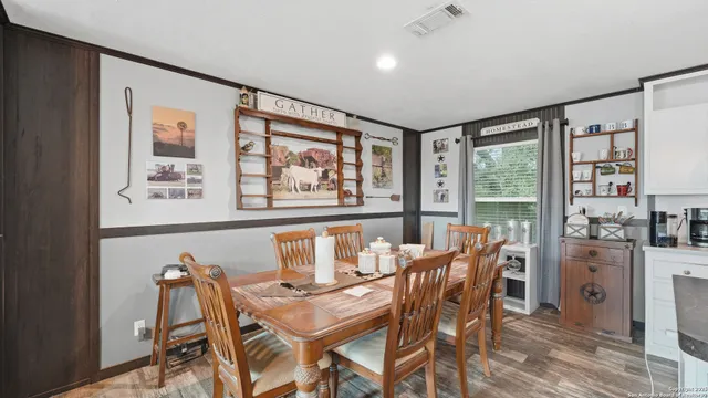 a living room with furniture tv and large window
