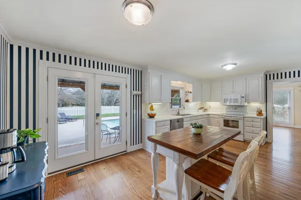 a kitchen with stainless steel appliances a sink stove and cabinets