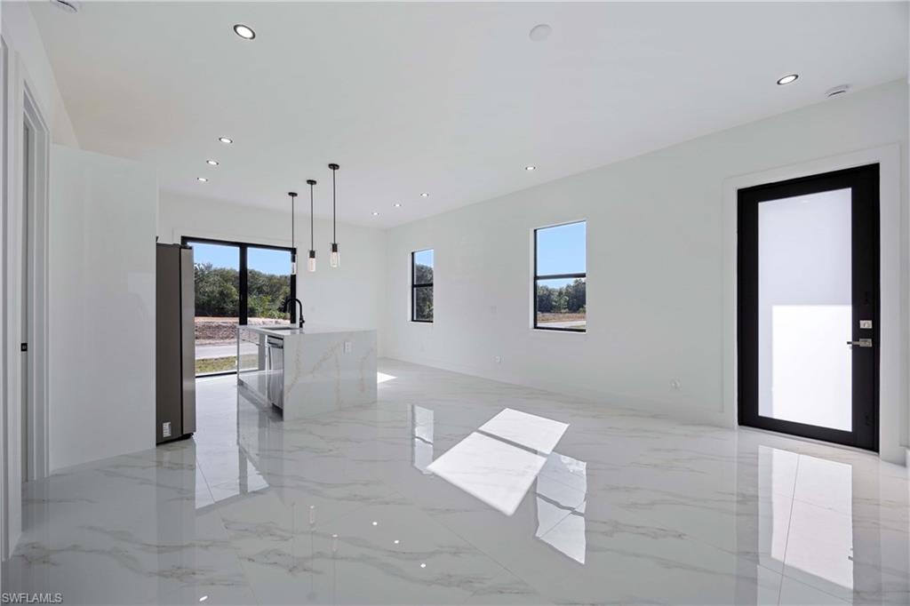 2700 49th Street Southwest Lehigh Acres, FL 33976 - Photo 7 of 24 Unfurnished room with light marble finish floors and recessed lighting