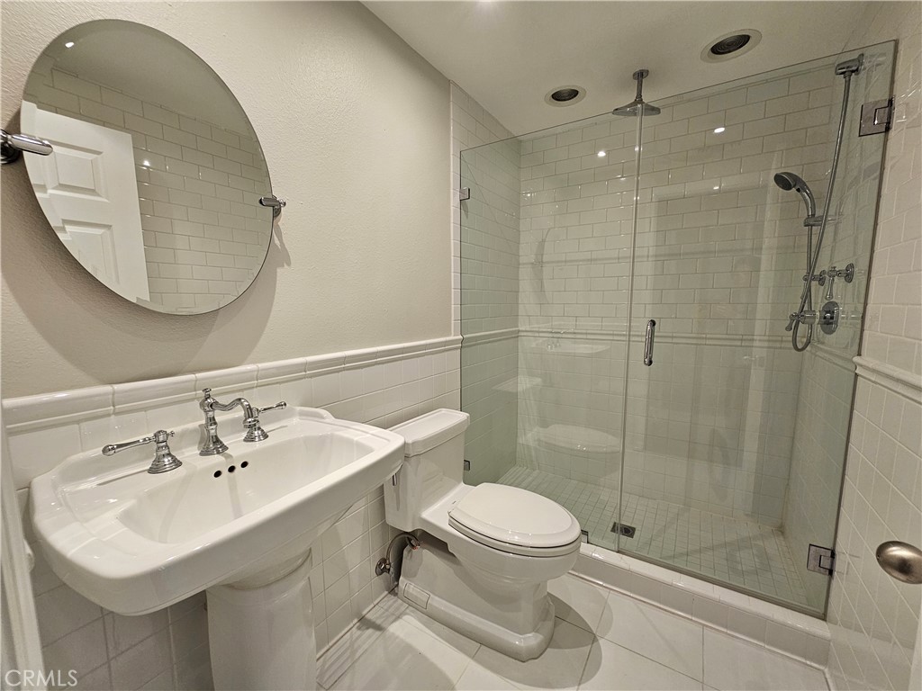 4068 Av. Sevilla Cypress, CA 90630 - Photo 16 of 17 a bathroom with a sink toilet and shower