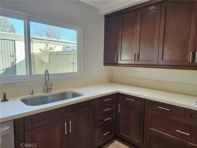 a kitchen with a sink and wooden cabinets