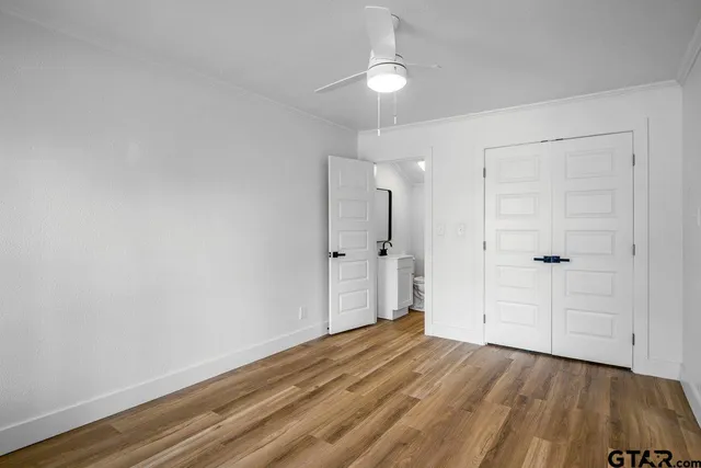 a view of a room with wooden floor and white walls