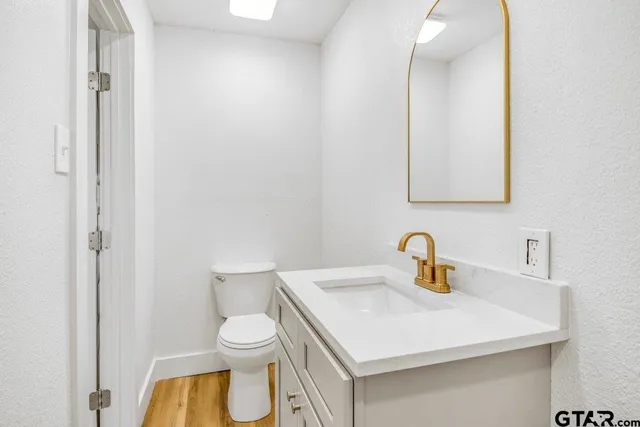 a bathroom with a toilet sink and mirror
