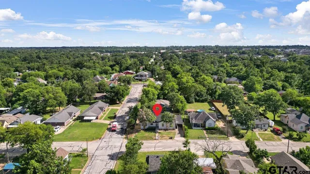 an aerial view of residential houses with outdoor space