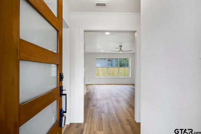 a view of hallway with wooden floor