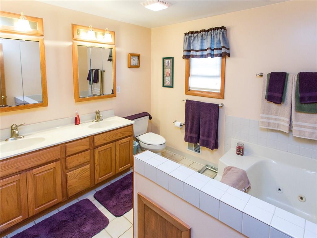 618 Cemetery Road Perryopolis, PA 15473 - Photo 4 of 25 Double bowl vanity with a ceramic tile floor and tub surround.
