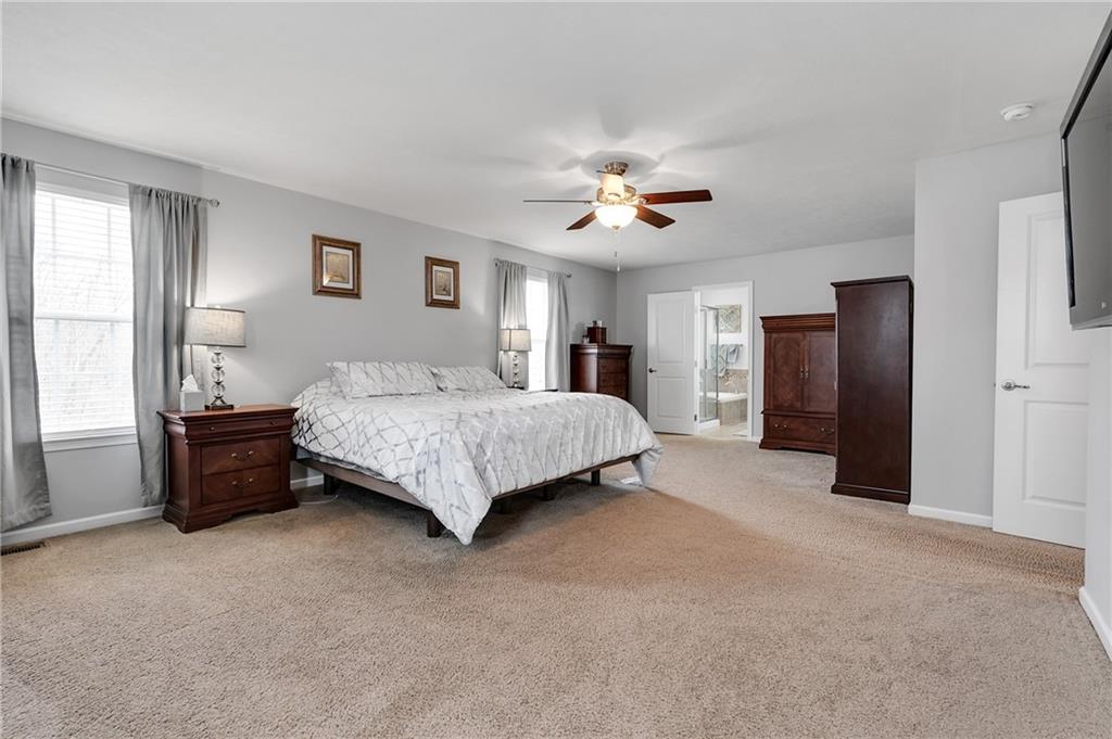 102 Pinyon Court McDonald, PA 15057 - Photo 14 of 24 a spacious bedroom with a bed and a chandelier