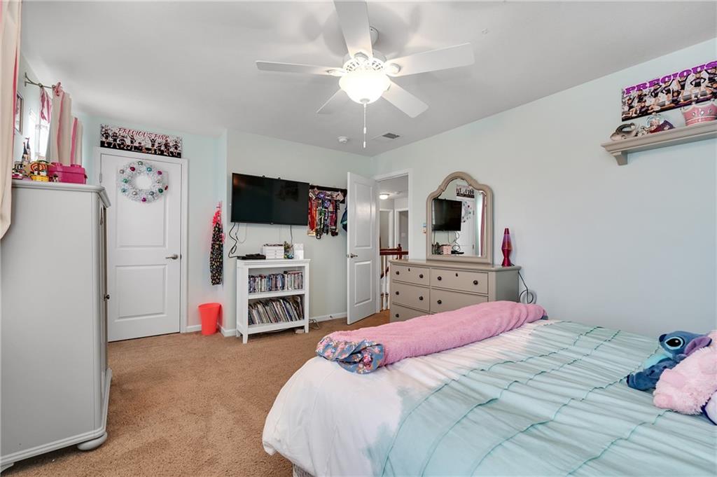 102 Pinyon Court McDonald, PA 15057 - Photo 16 of 24 a bedroom with a bed a flat screen tv and a chandelier
