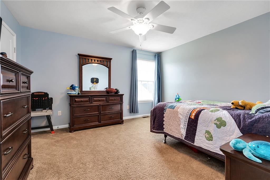 102 Pinyon Court McDonald, PA 15057 - Photo 17 of 24 a bedroom with a bed and a chandelier