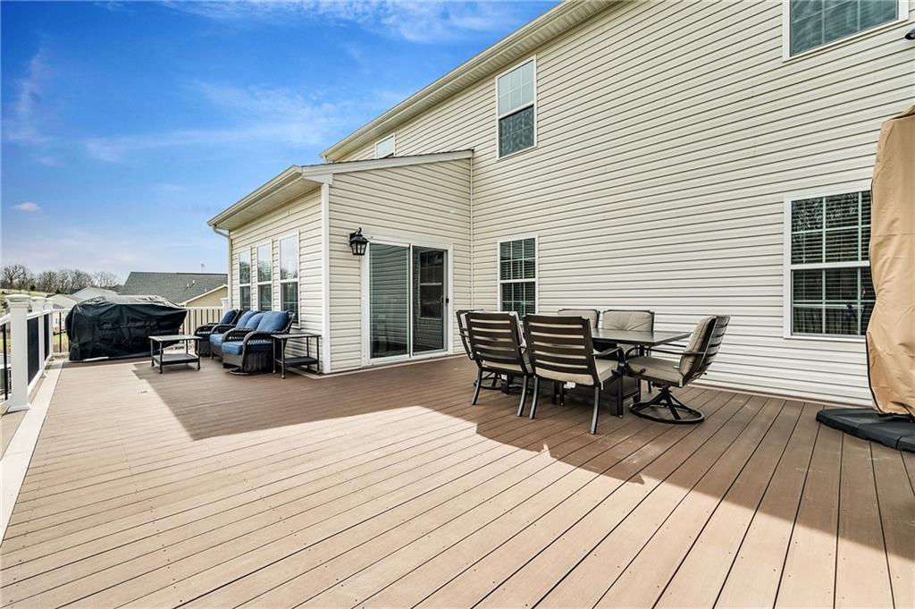 102 Pinyon Court McDonald, PA 15057 - Photo 21 of 24 a view of a roof deck with table and chairs with wooden floor and fence