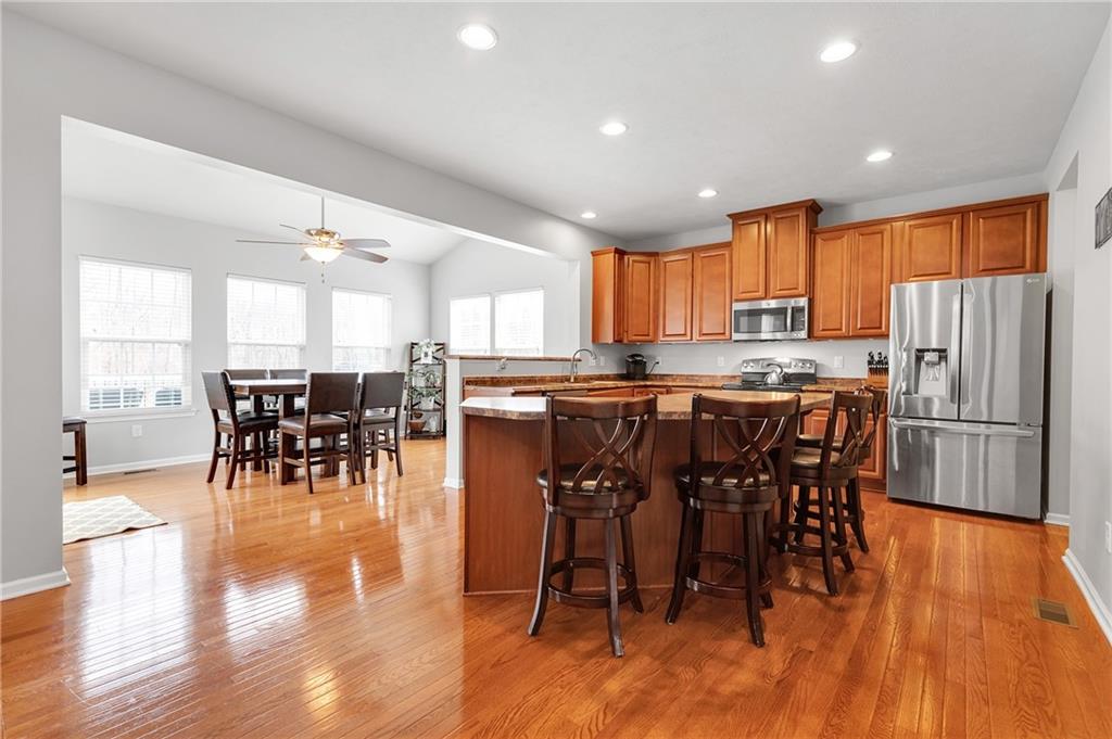 102 Pinyon Court McDonald, PA 15057 - Photo 6 of 24 a kitchen with stainless steel appliances a dining table chairs and a refrigerator