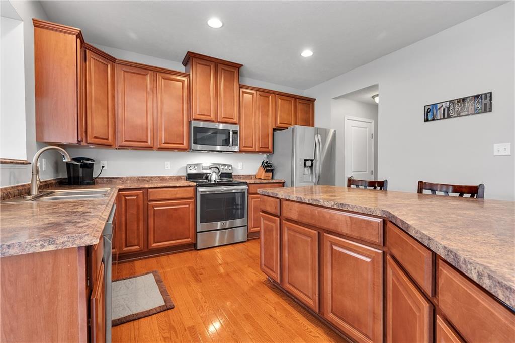 102 Pinyon Court McDonald, PA 15057 - Photo 7 of 24 a kitchen with stainless steel appliances granite countertop a stove sink refrigerator and cabinets