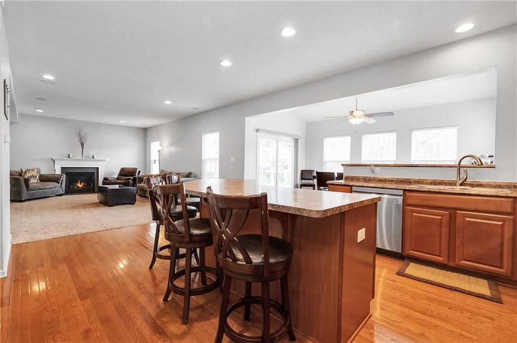 102 Pinyon Court McDonald, PA 15057 - Photo 8 of 24 a kitchen with stainless steel appliances granite countertop a table chairs sink refrigerator and microwave