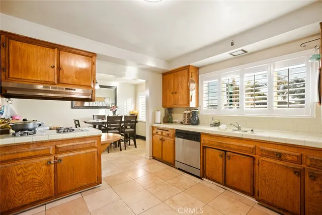 a room with kitchen island granite countertop lots of counter top space and stainless steel appliances