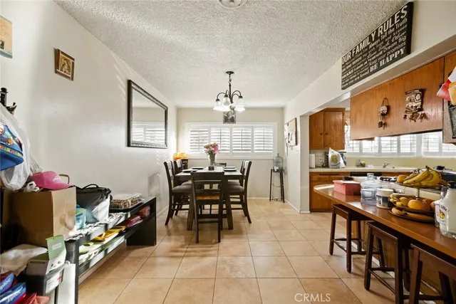 a view of a dining room with furniture and chandelier