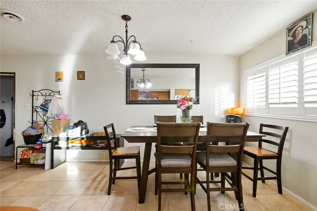 a view of a dining room with furniture and a chandelier