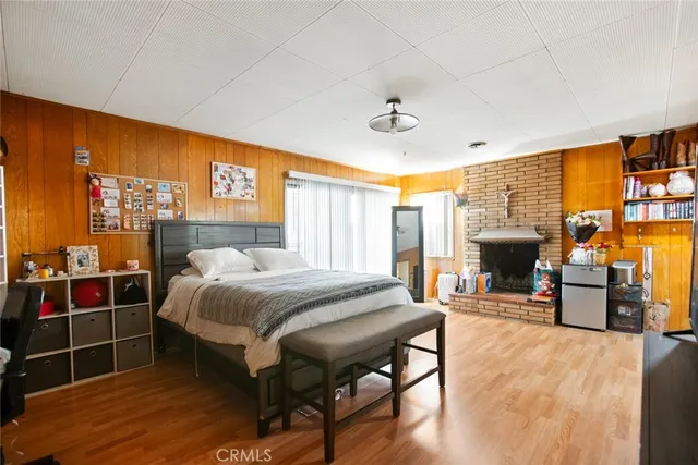 a bedroom with a bed and a fireplace