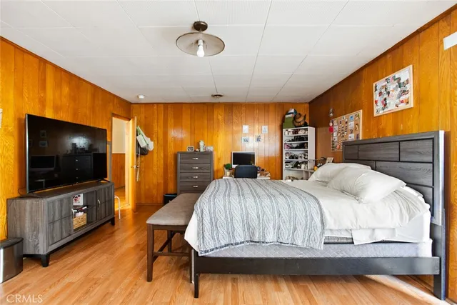 a bedroom with a bed and a flat screen tv