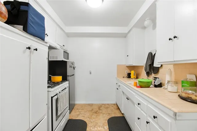 a kitchen with appliances and cabinets