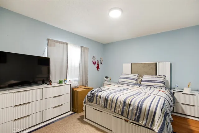 a bedroom with a bed and a flat screen tv