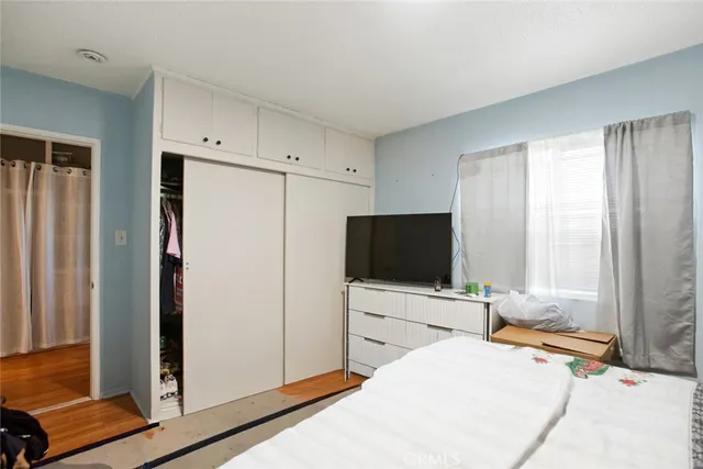 a bedroom with a bed and a flat screen tv