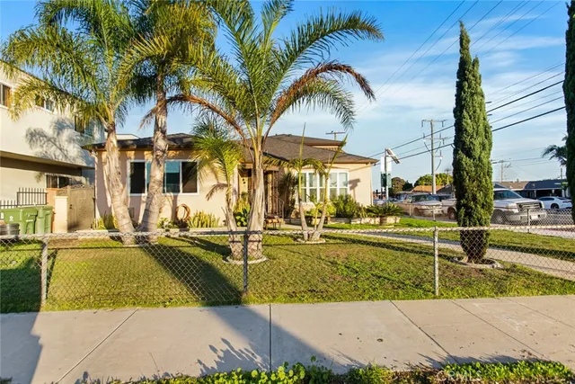 a view of a swimming pool with a lawn chairs under an umbrella