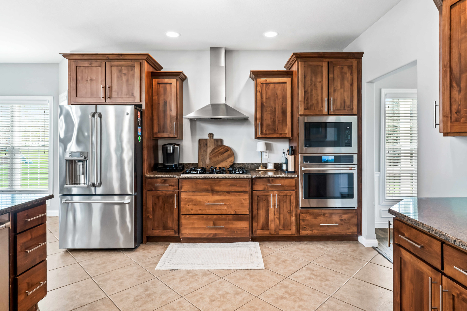 2213 Tyler Trail Bloomington, IL 61705 - Photo 14 of 58 a kitchen with granite countertop a refrigerator and a stove top oven