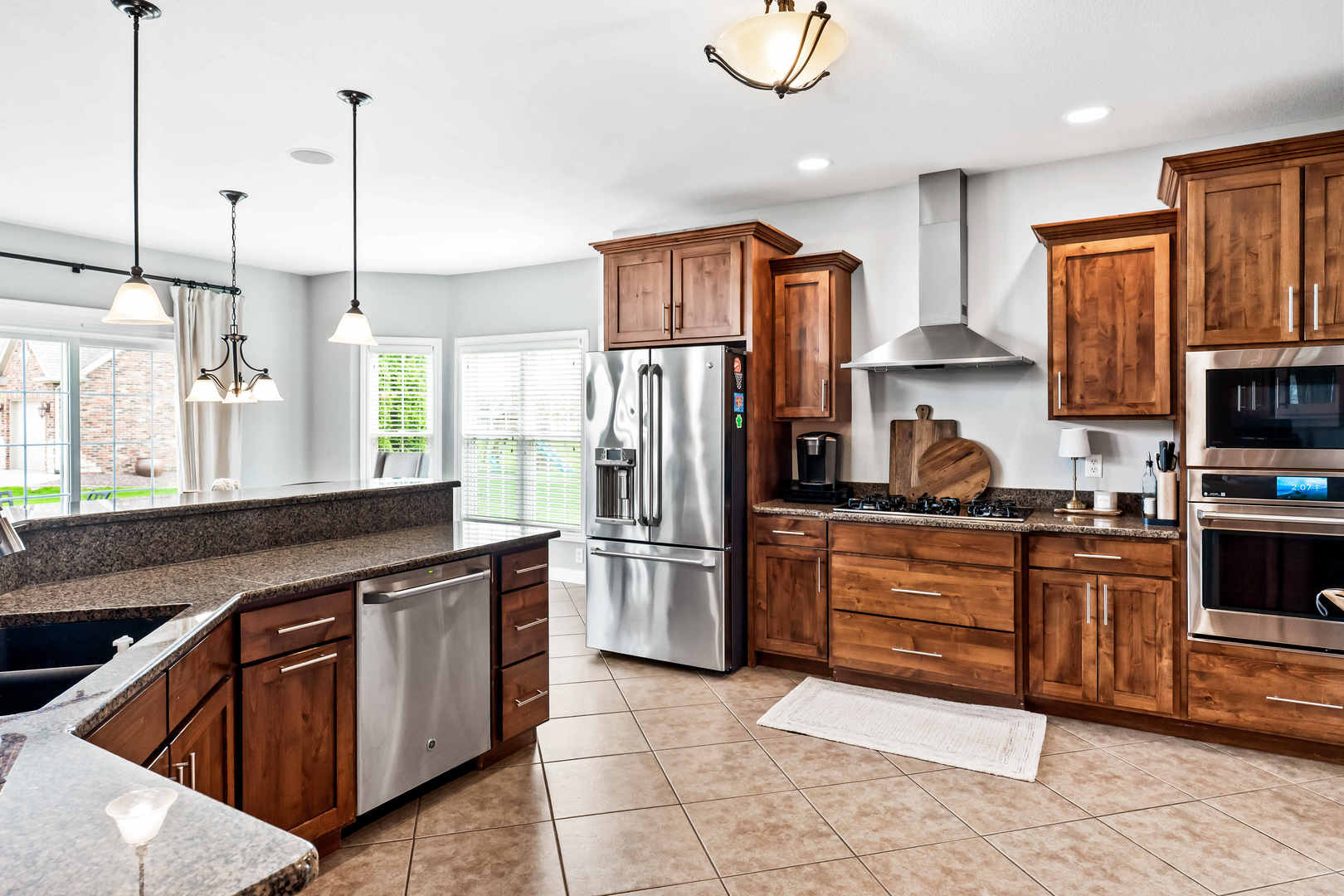 2213 Tyler Trail Bloomington, IL 61705 - Photo 15 of 58 a kitchen with stainless steel appliances granite countertop a refrigerator a stove top oven a sink and dishwasher