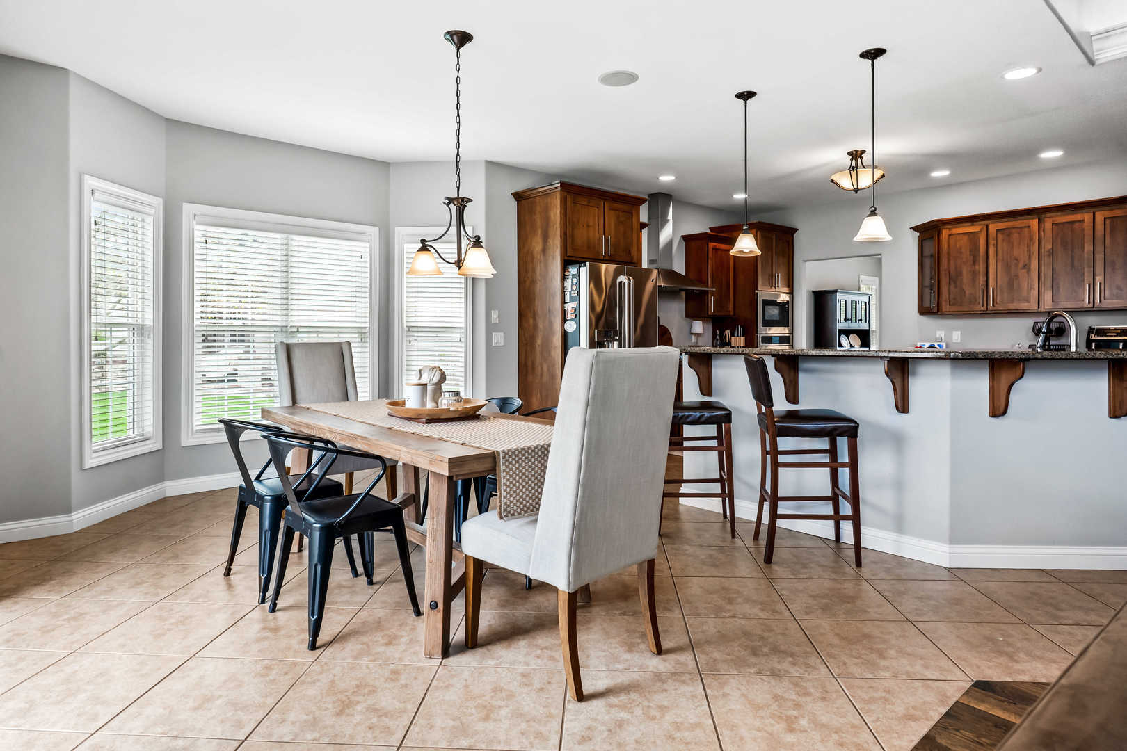 2213 Tyler Trail Bloomington, IL 61705 - Photo 20 of 58 a dining area with a table chairs and a kitchen view