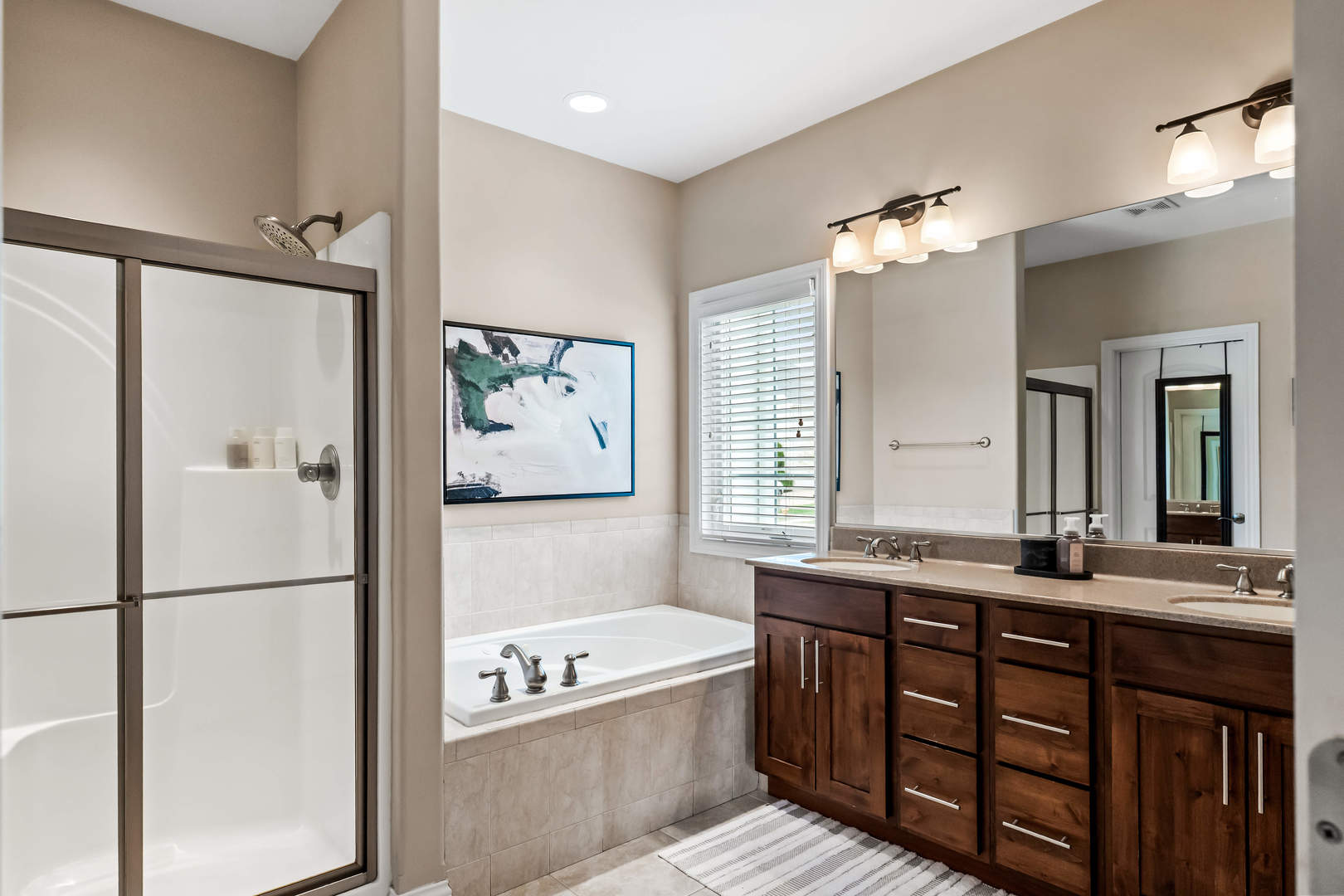 2213 Tyler Trail Bloomington, IL 61705 - Photo 26 of 58 a bathroom with a bathtub double vanity sink and a mirror