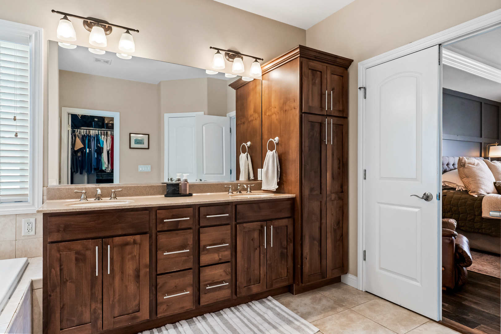 2213 Tyler Trail Bloomington, IL 61705 - Photo 28 of 58 a bathroom with a double vanity sink and a mirror
