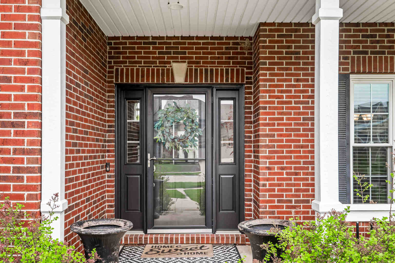 2213 Tyler Trail Bloomington, IL 61705 - Photo 4 of 58 a view of a house with a potted plant and a window