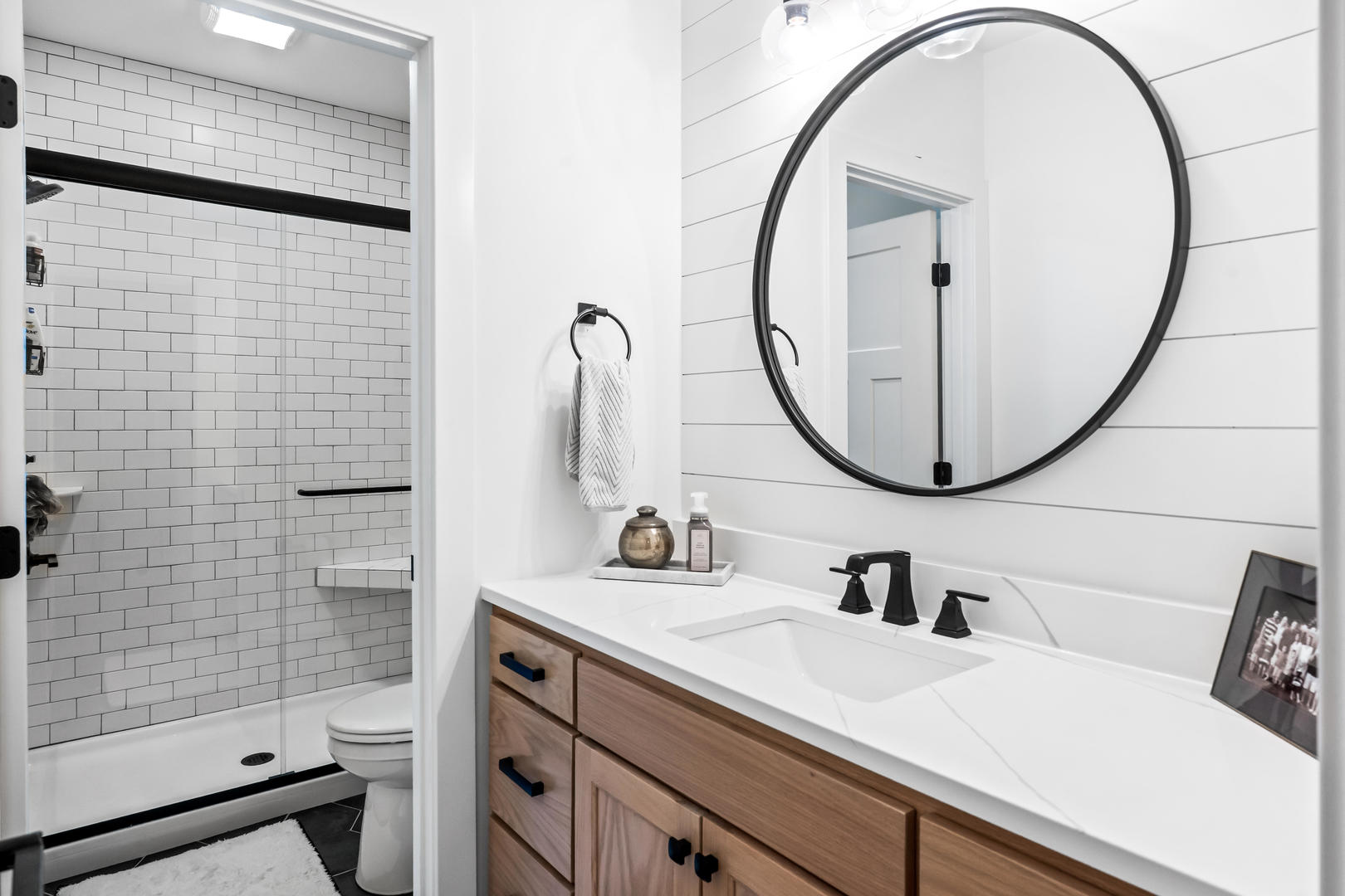 2213 Tyler Trail Bloomington, IL 61705 - Photo 47 of 58 a bathroom with a sink a mirror a vanity and a shower