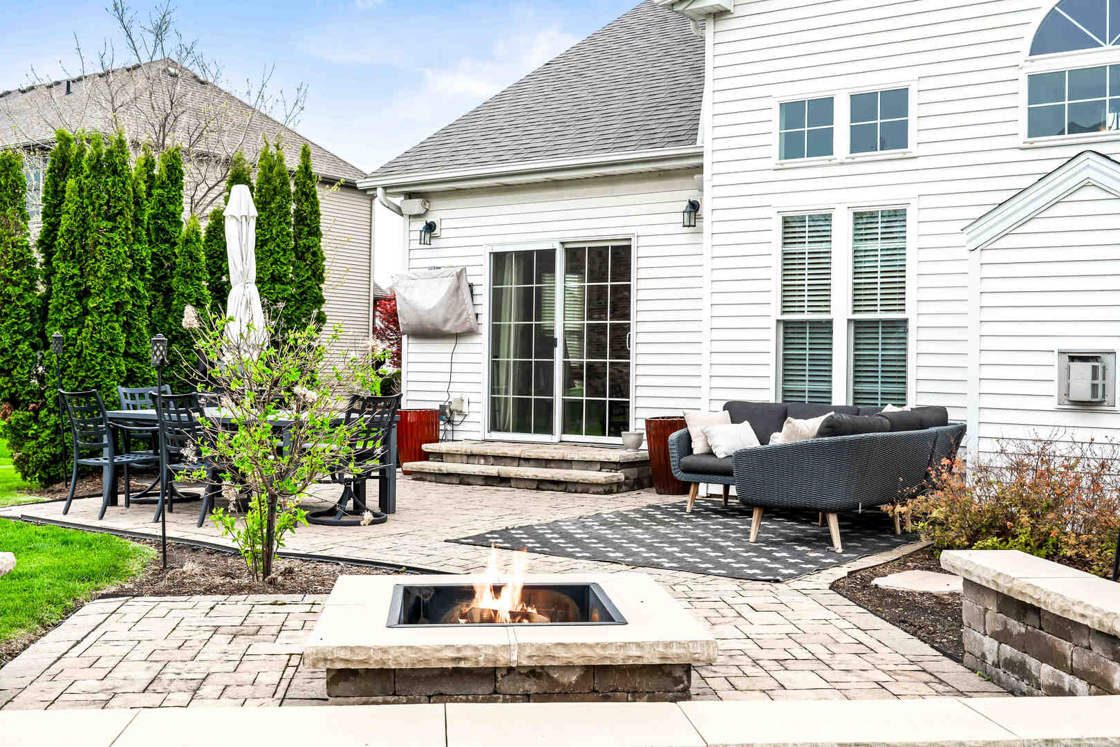 2213 Tyler Trail Bloomington, IL 61705 - Photo 55 of 58 a view of a chairs and table in the back yard of the house
