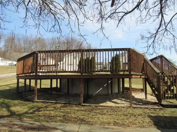 a view of wooden house with a yard
