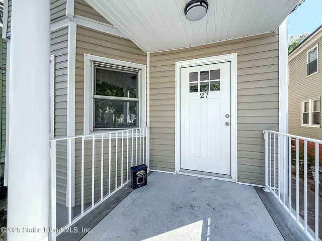 a view of porch with a door and wooden floor