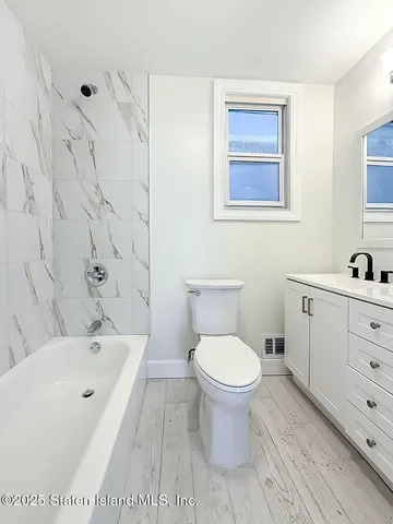 a bathroom with a toilet and a bathtub