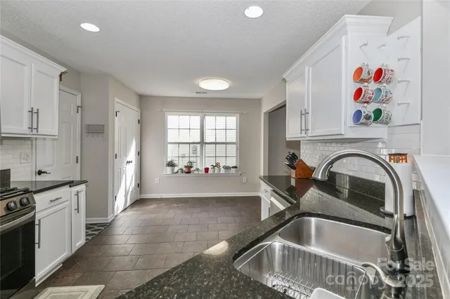 a kitchen with a refrigerator and a sink