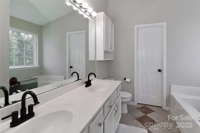 a bathroom with a sink a toilet and bathtub
