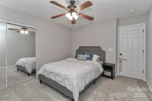 a bedroom with bed and a chandelier