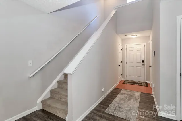 a view of a hallway with wooden floor and entryway
