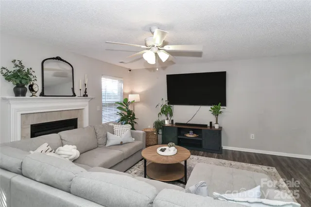 a living room with furniture a flat screen tv and a fireplace