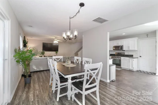 a view of a dining room with furniture wooden floor and chandelier