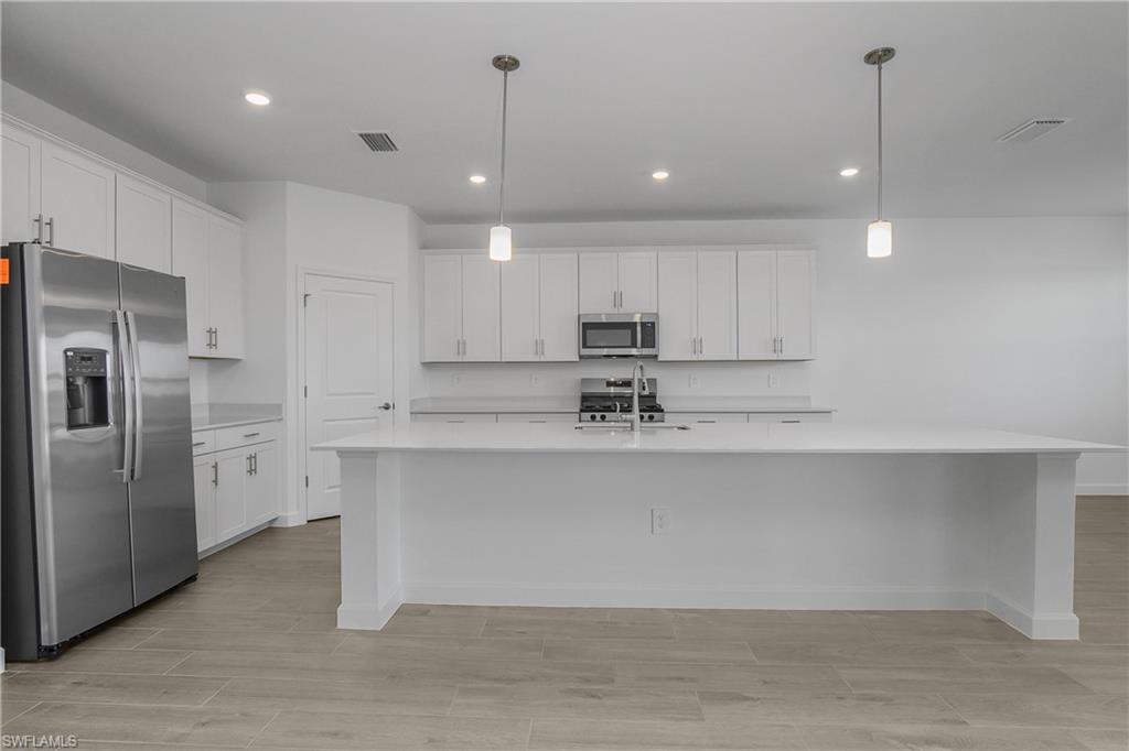 21094 Verawood Loop Estero, FL 33928 - Photo 9 of 49 a view of kitchen with center island and stainless steel appliances