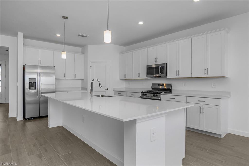 21094 Verawood Loop Estero, FL 33928 - Photo 13 of 49 a kitchen with refrigerator a sink and a stove