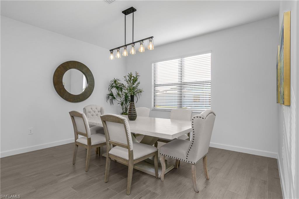 21094 Verawood Loop Estero, FL 33928 - Photo 15 of 49 a dining room with furniture a chandelier and window