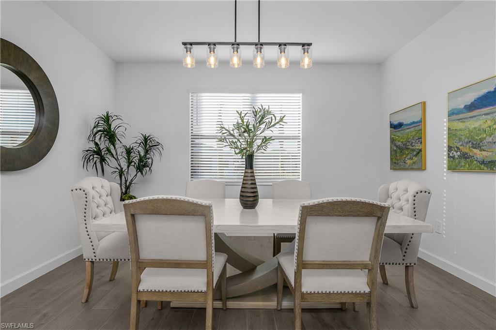 21094 Verawood Loop Estero, FL 33928 - Photo 16 of 49 a dining room with furniture potted plants and wooden floor