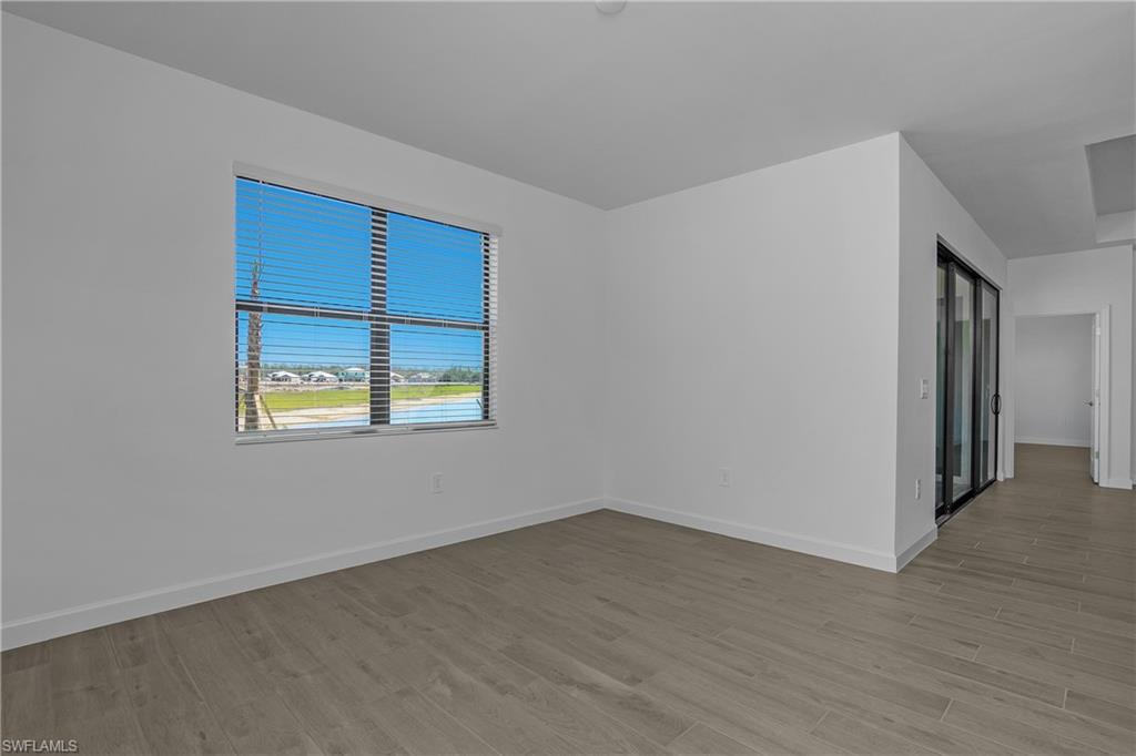 21094 Verawood Loop Estero, FL 33928 - Photo 17 of 49 a view of an empty room with wooden floor and a window
