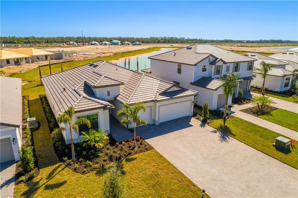 21094 Verawood Loop Estero, FL 33928 - Photo 2 of 49 a view of a patio with lawn chairs under an umbrella